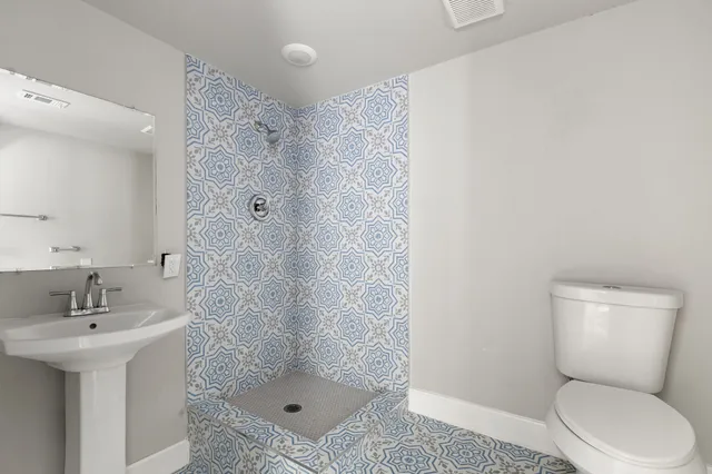 a bathroom with a sink toilet and shower