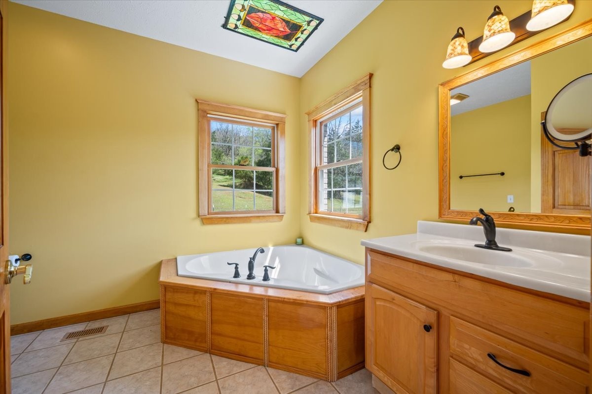 216 Old Wolf Hill Road Bethpage, TN 37022 - Photo 21 of 70 a bathroom with a tub sink and mirror