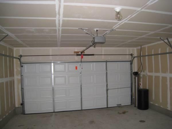 211 Woodley Road Leander, TX 78641 - Photo 15 of 15 An attached garage features concrete flooring, drywalled walls, and an automatic garage door opener.