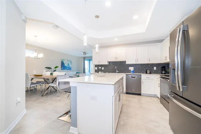 a kitchen with a sink a counter top space stainless steel appliances and cabinets