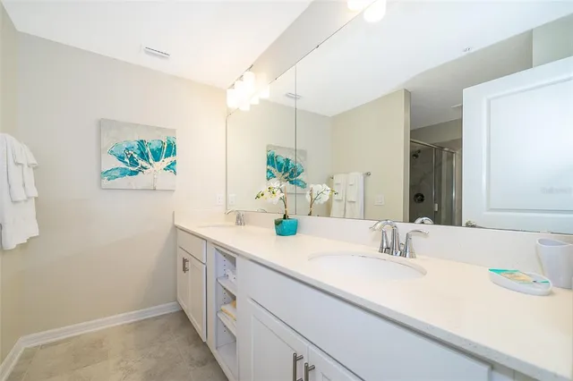a bathroom with a sink double vanity and a granite