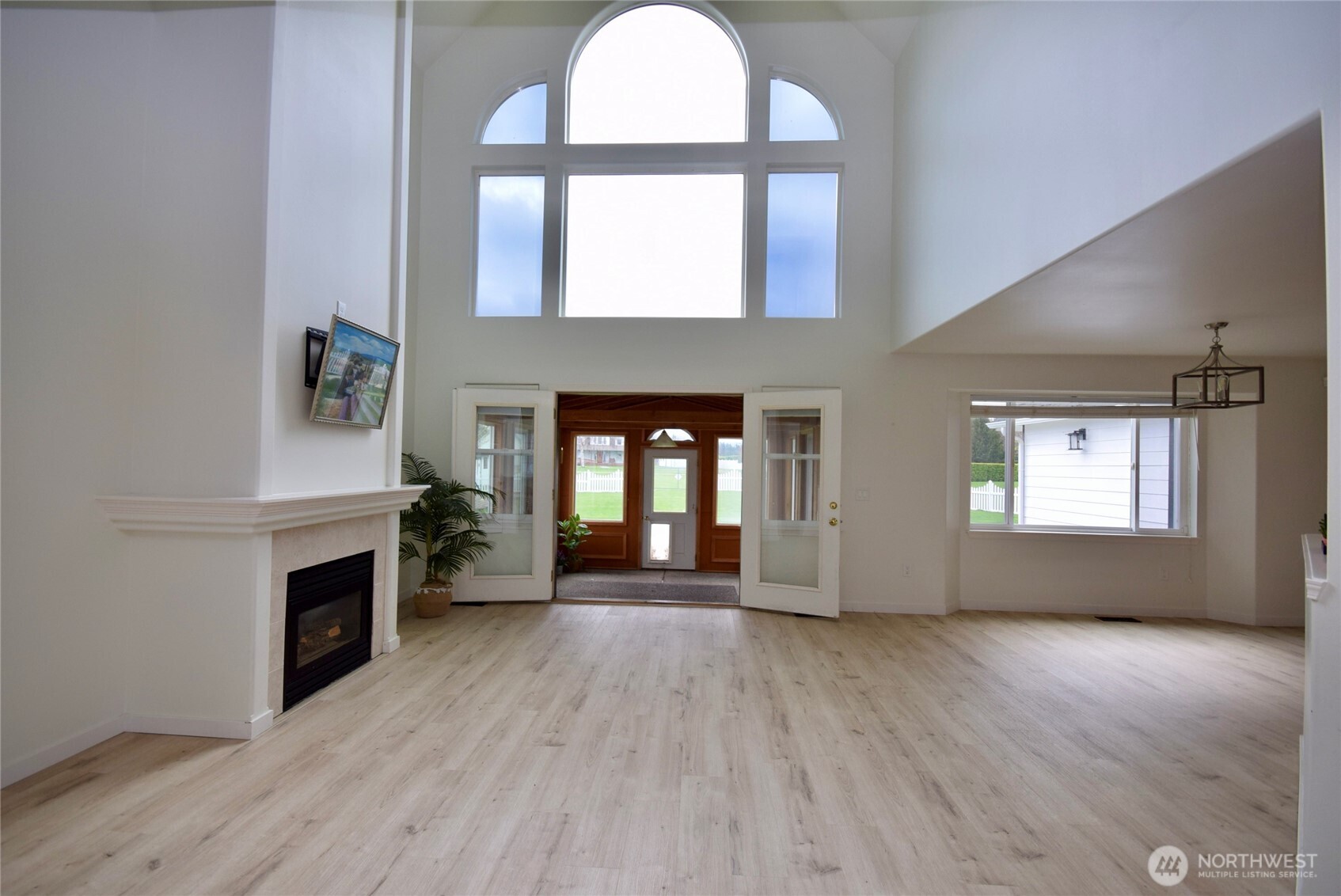 71 John Carl Road Sequim, WA 98382 - Photo 6 of 37 an empty room with wooden floor a fireplace and windows