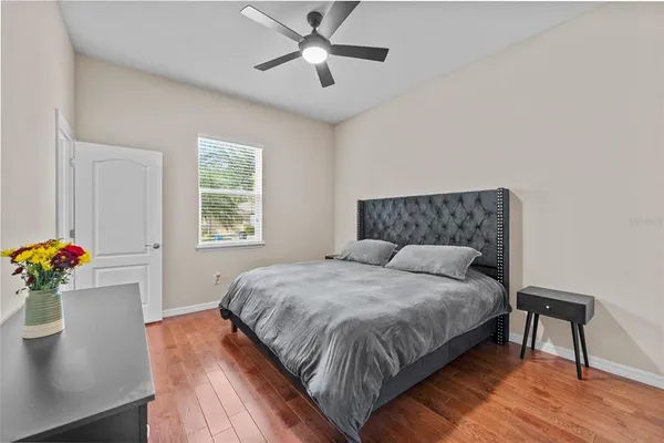 a bedroom with a bed chandelier and a window