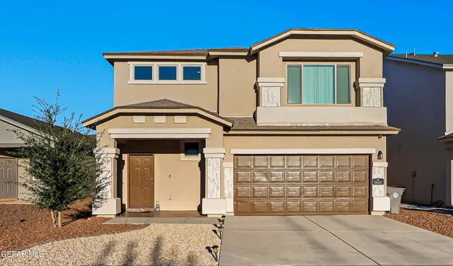 a front view of a house with a garage