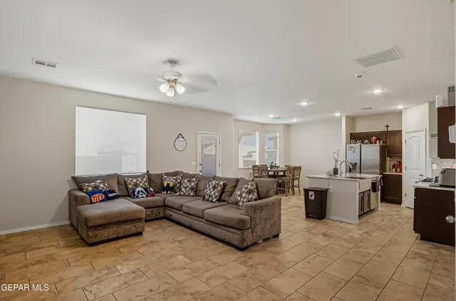 a living room with furniture and kitchen view