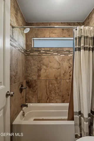 a bathroom with a shower and a tub