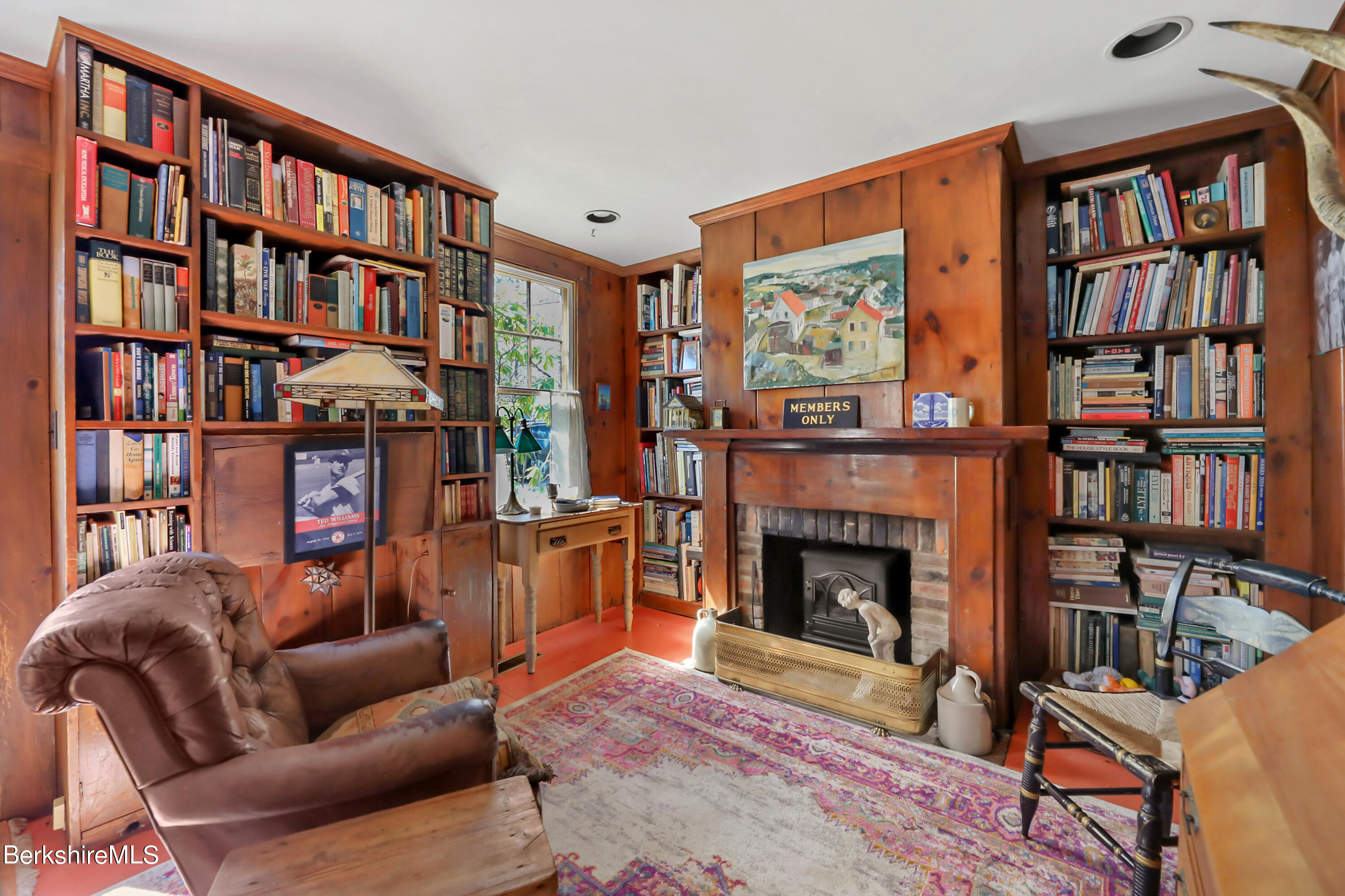 575 Sheffield Plain Sheffield, MA 01257 - Photo 18 of 42 a living room with furniture a bookshelf and a fireplace