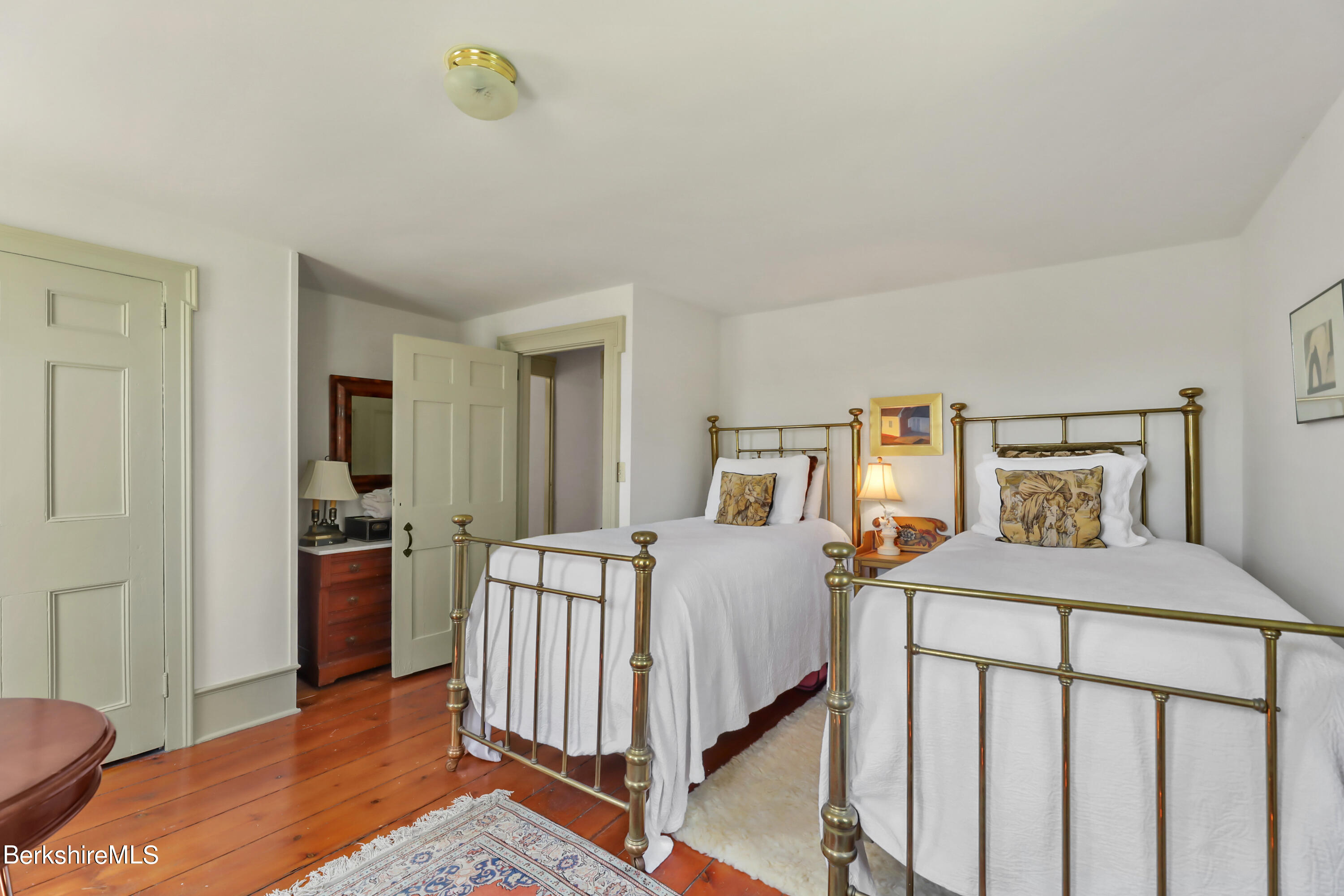 575 Sheffield Plain Sheffield, MA 01257 - Photo 31 of 42 a bedroom with a bed and wooden floor