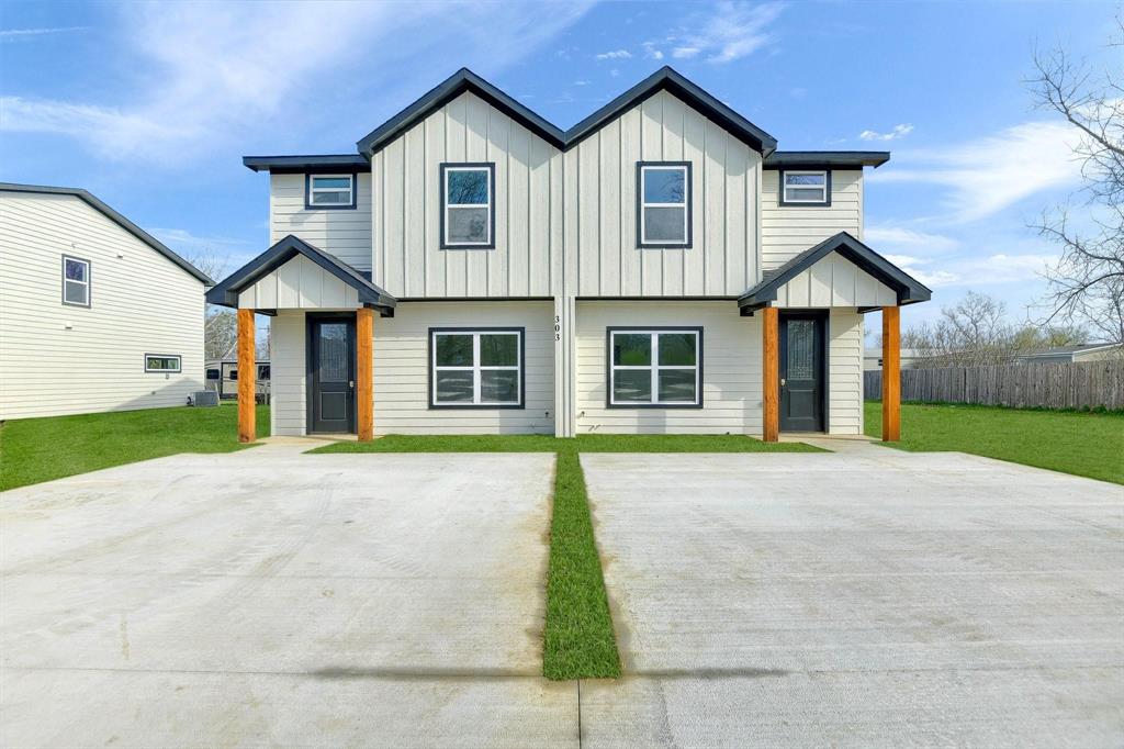 301 Anderson Street, Unit B Whitesboro, TX 76273 - Photo 1 of 16 a front view of a house with a yard and garage