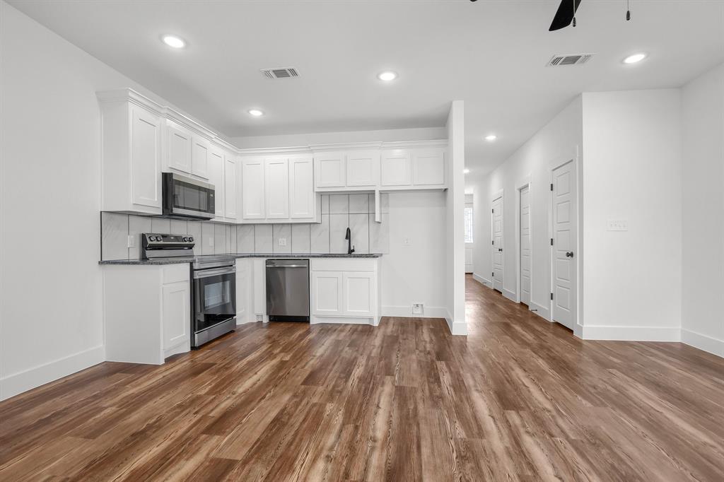 301 Anderson Street, Unit B Whitesboro, TX 76273 - Photo 3 of 16 a kitchen with a refrigerator and a stove top oven