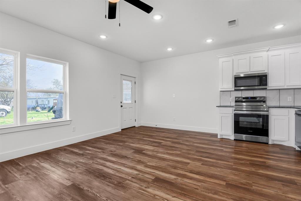 301 Anderson Street, Unit B Whitesboro, TX 76273 - Photo 5 of 16 a view of kitchen with sink microwave and stove top oven