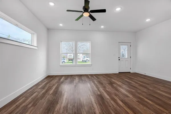 wooden floor in an empty room with a window