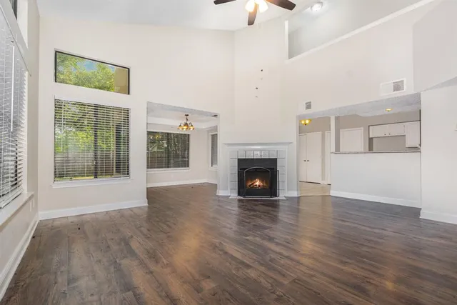 a view of empty room with wooden floor and fireplace