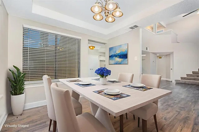 a view of a dining room with furniture and a potted plant