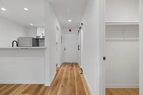 a view of a hallway with a kitchen