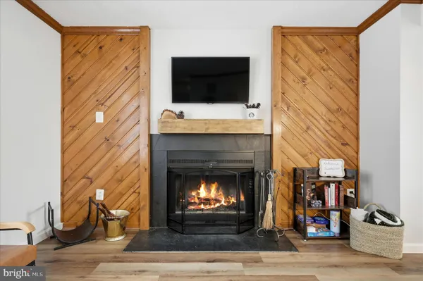 a living room with a fireplace and a flat screen tv