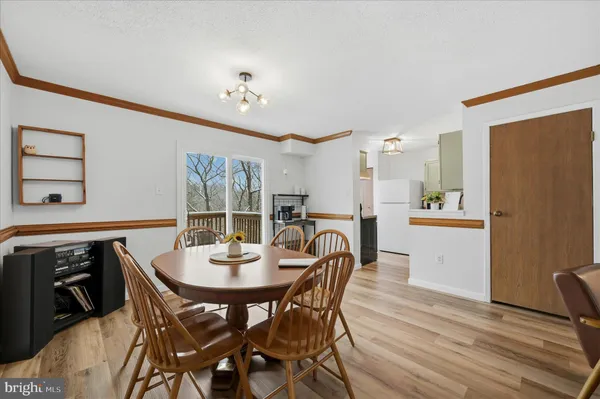 a view of a dining room with furniture and window