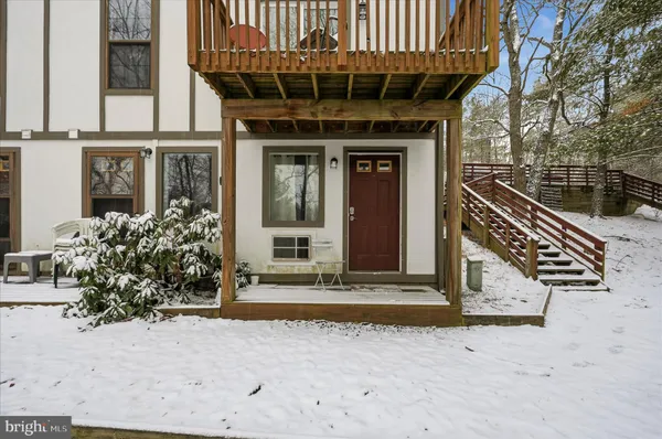 a bathroom with a glass shower door and a window