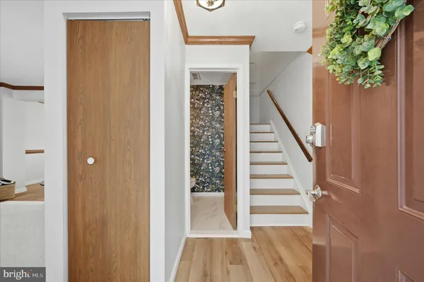 a view of a hallway with wooden floor and entryway