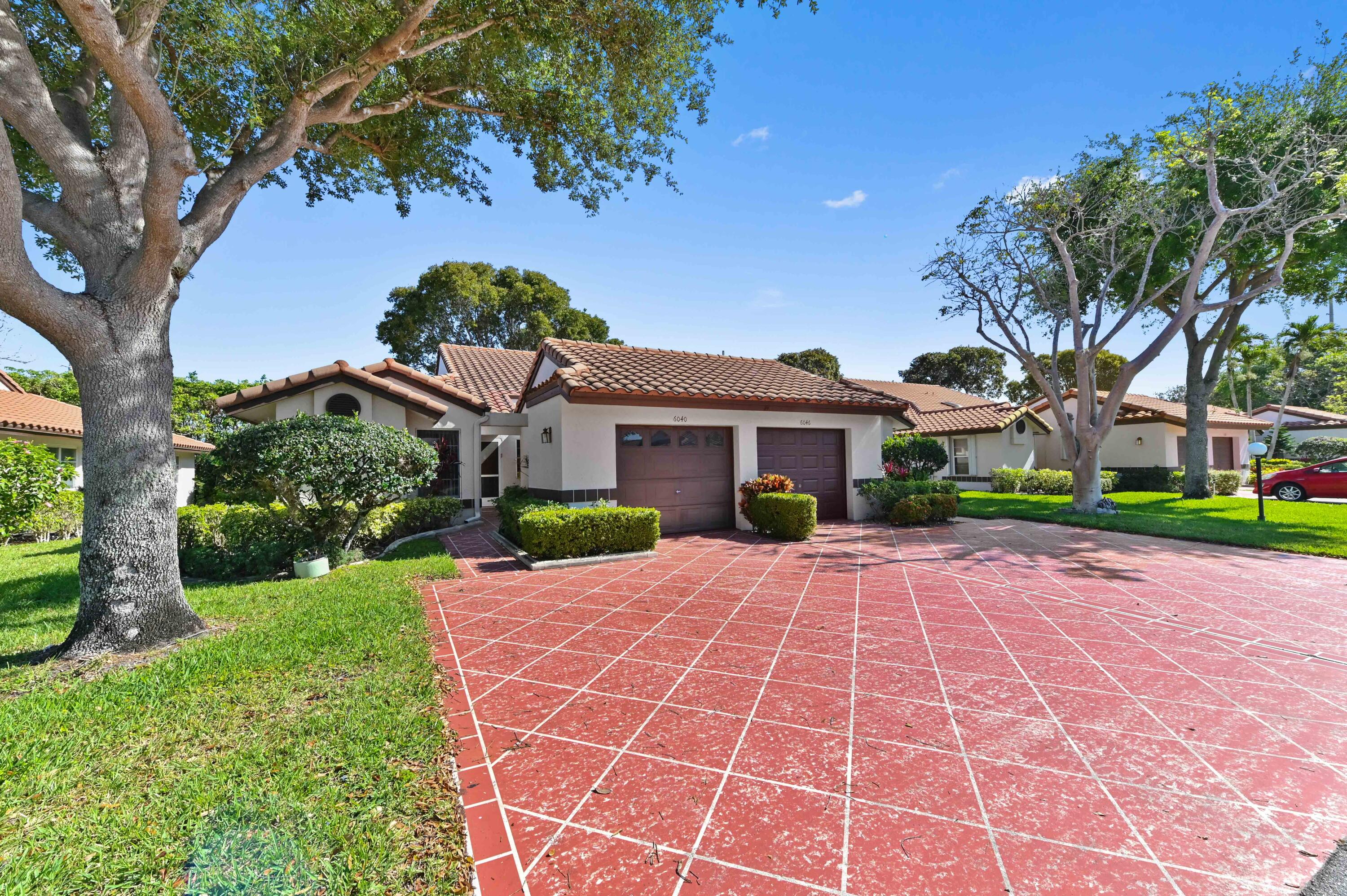 6040 Waldwick Circle Delray Beach, FL 33484 - Photo 2 of 75 a front view of a house with a yard