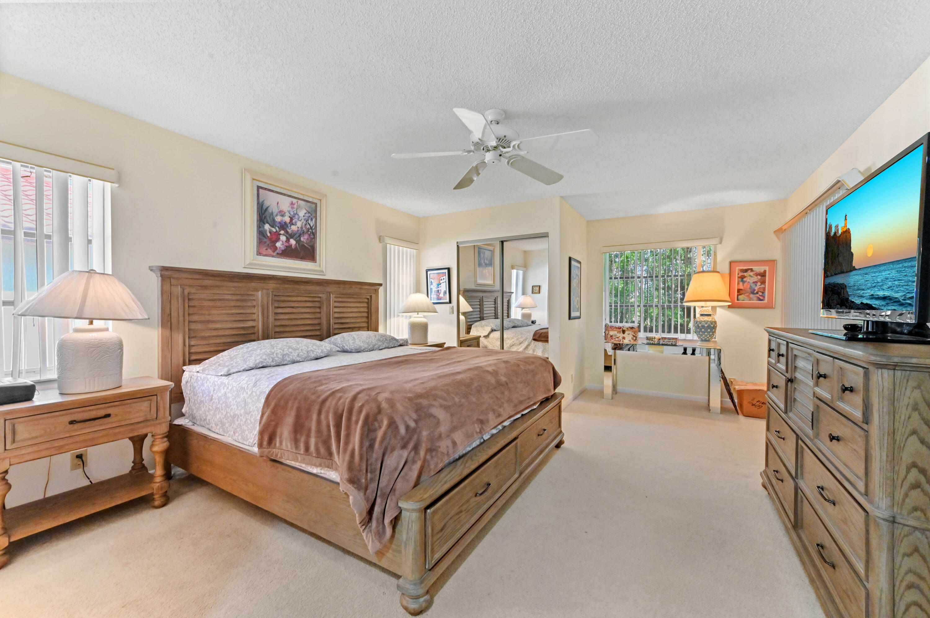6040 Waldwick Circle Delray Beach, FL 33484 - Photo 21 of 75 a spacious bedroom with a bed and a flat screen television