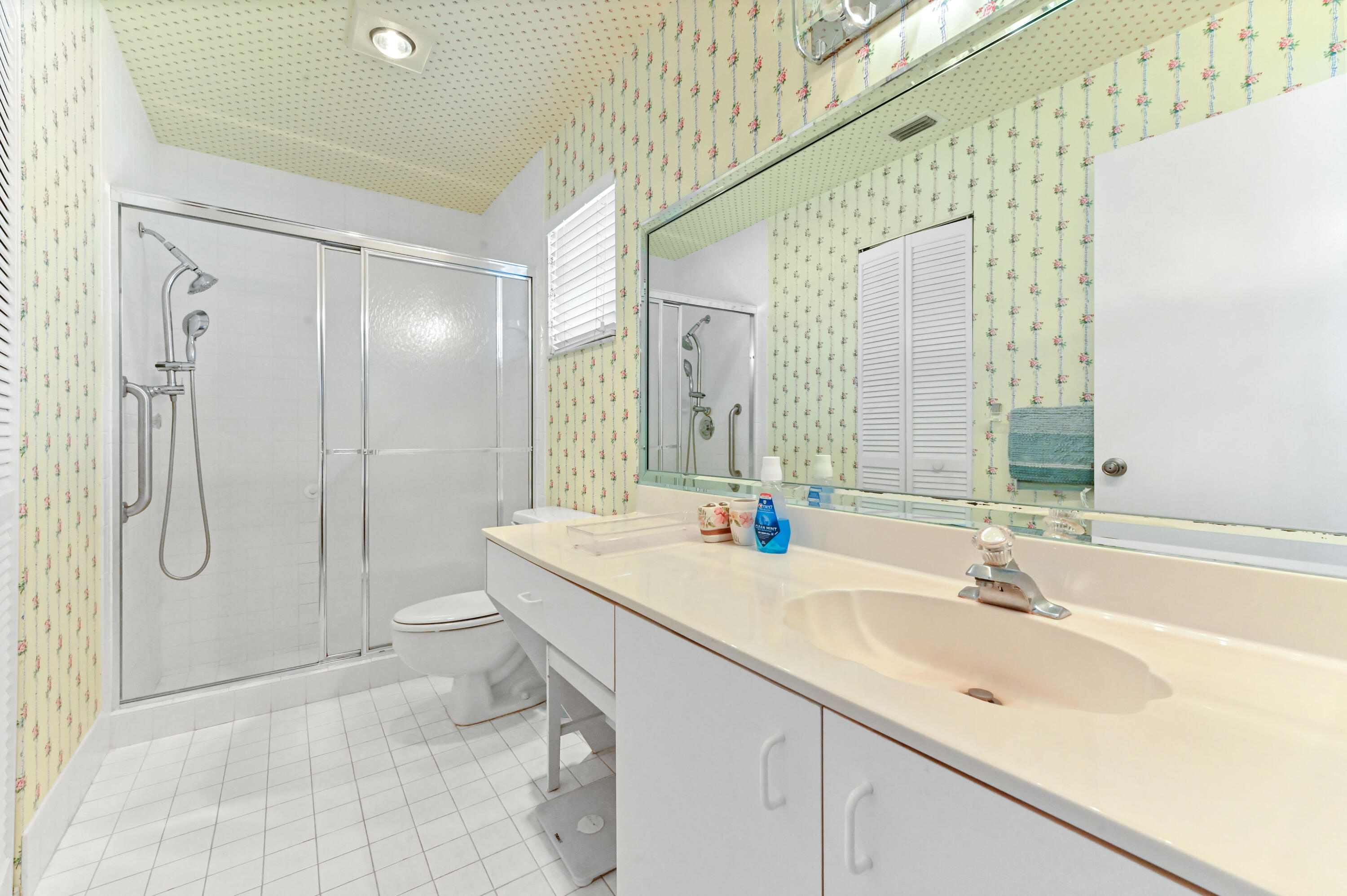 6040 Waldwick Circle Delray Beach, FL 33484 - Photo 23 of 75 a bathroom with a sink a toilet and shower