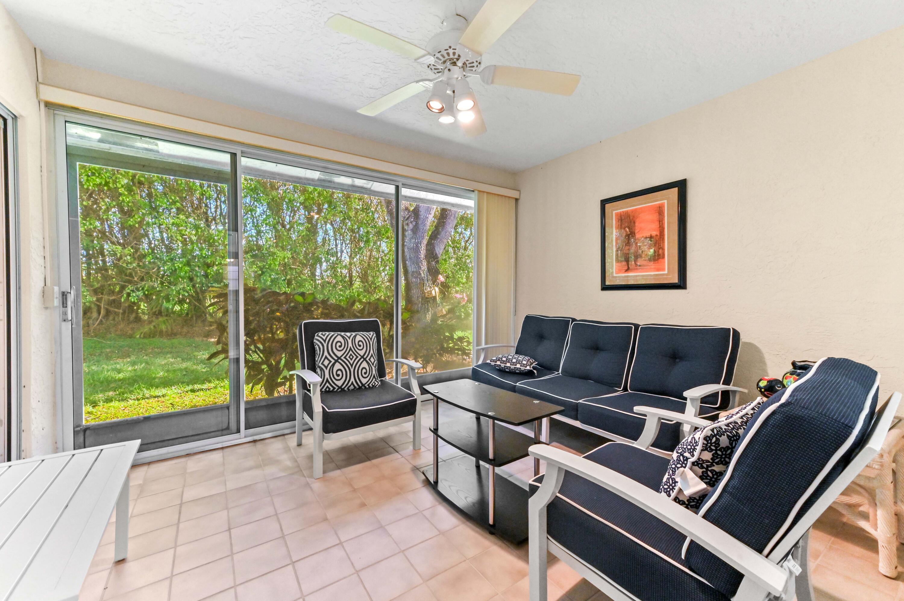 6040 Waldwick Circle Delray Beach, FL 33484 - Photo 24 of 75 a living room with furniture and a floor to ceiling window