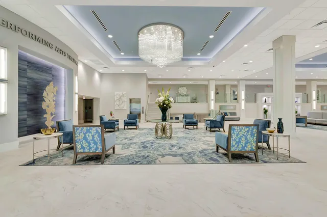 a living room with furniture and a chandelier