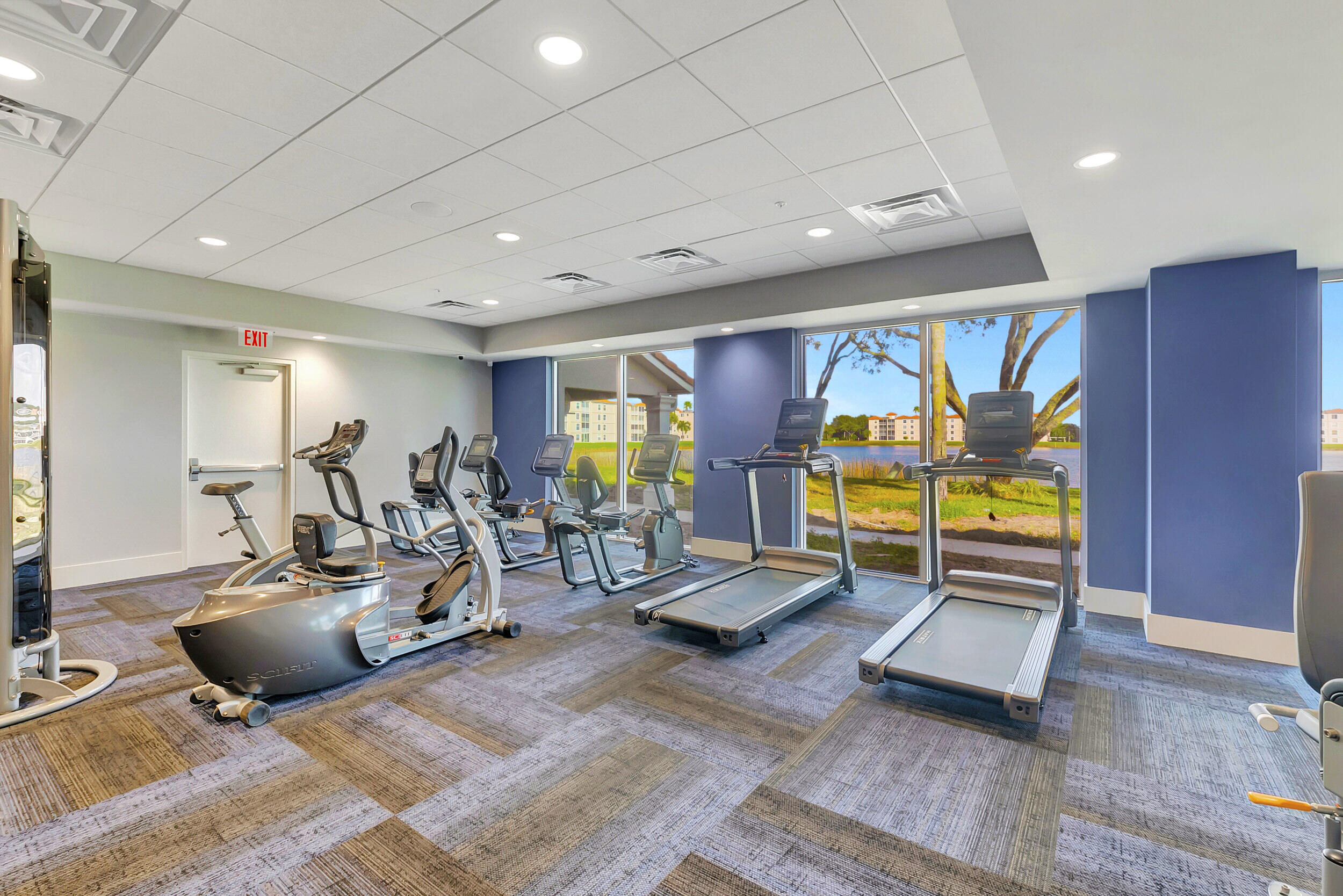 6040 Waldwick Circle Delray Beach, FL 33484 - Photo 60 of 75 a living room with gym equipment and a large window