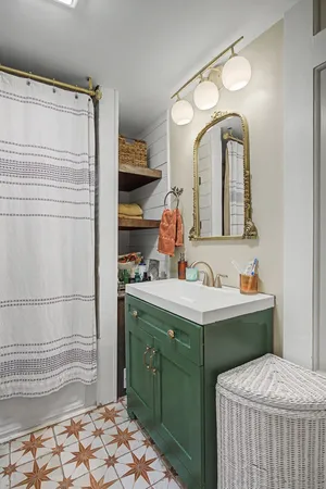 a bathroom with a sink a toilet and a shower