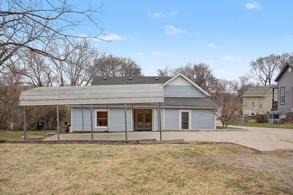 a view of a white house with a yard