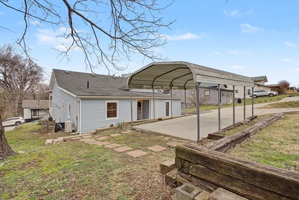 a view of a house with snow on the road