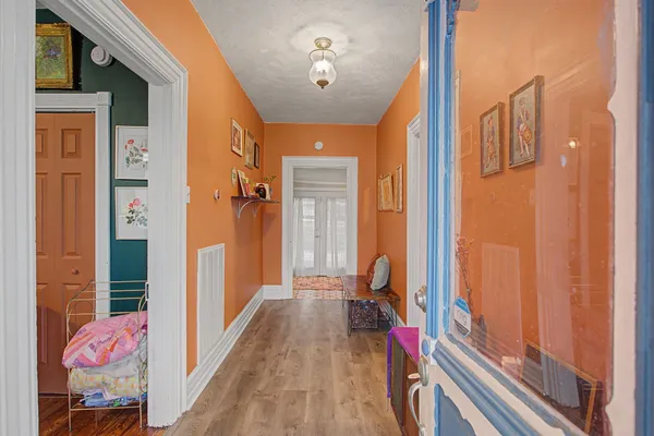 a view of a hallway to a livingroom with furniture