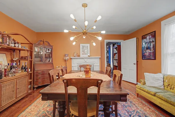 a view of a a dining room with furniture window and wooden floor