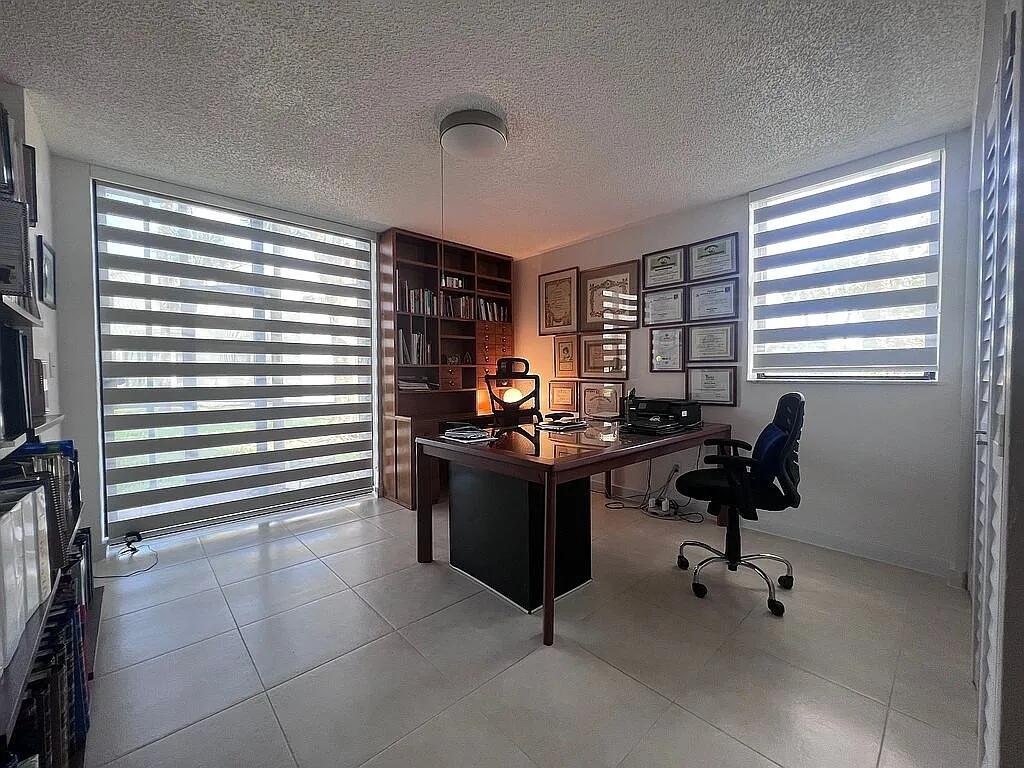 6463 La Costa Drive, Unit 105 Boca Raton, FL 33433 - Photo 20 of 40 a view of a workspace with furniture and a window