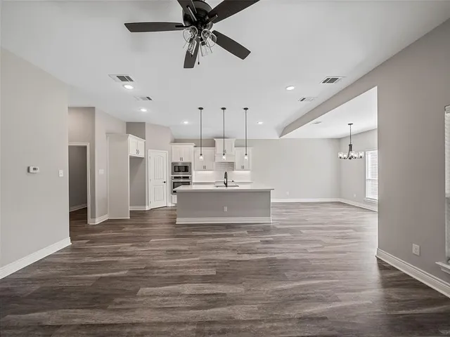 a view of kitchen with refrigerator microwave and cabinets