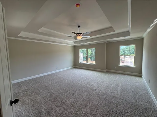 a view of a livingroom with a ceiling fan and window