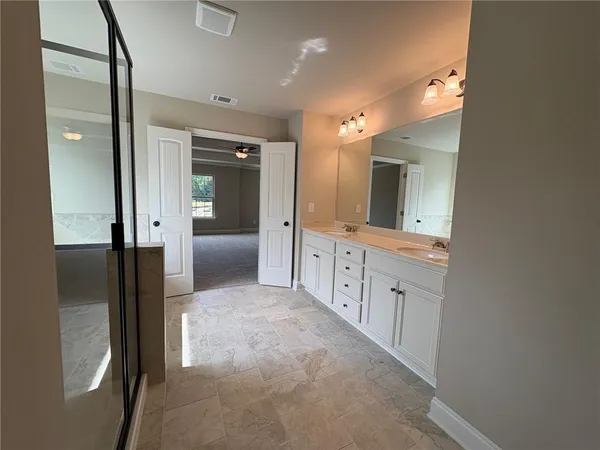 a bathroom with a double vanity sink and mirror