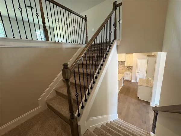 a view of entryway and hall with wooden floor