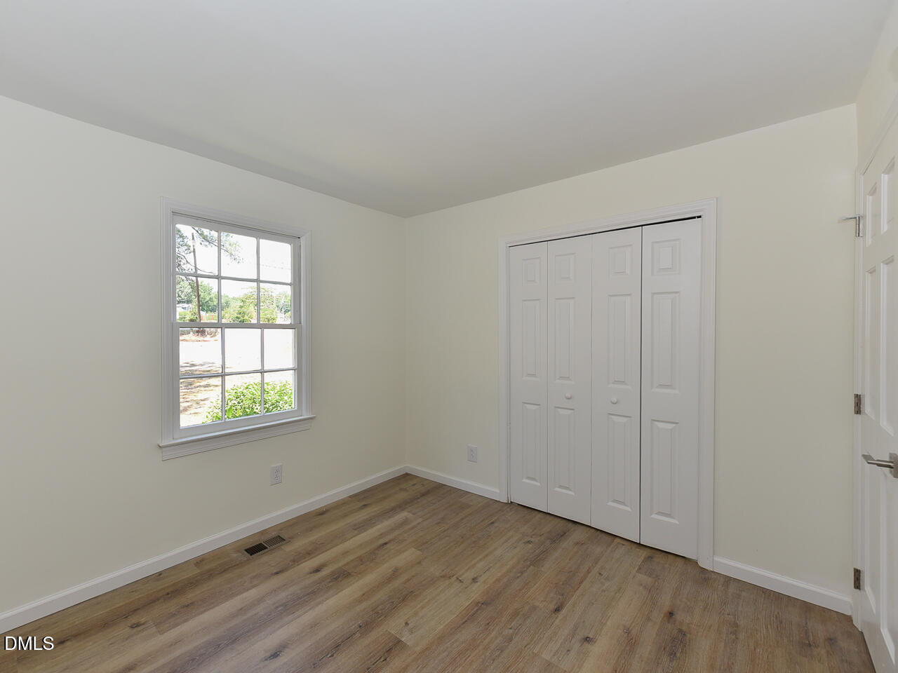 939 Cheves Road Zebulon, NC 27597 - Photo 16 of 21 an empty room with wooden floor and windows
