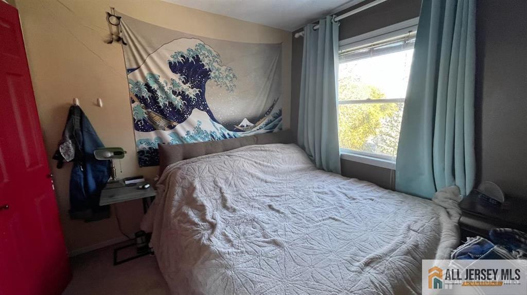 102 Gracey Street Edison, NJ 08817 - Photo 11 of 16 a bed sitting in a room next to a window