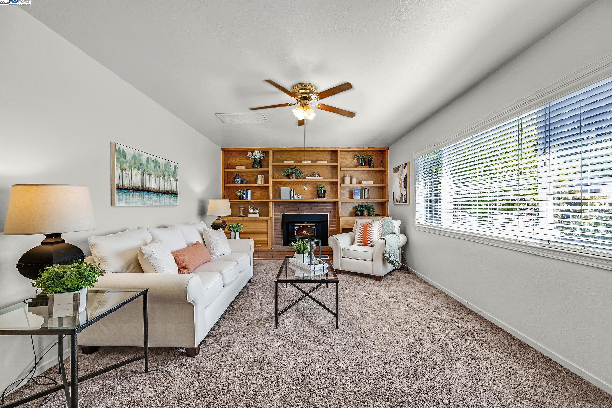 596 Tyler Avenue Livermore, CA 94550 - Photo 11 of 36 a living room with furniture a fireplace and a large window