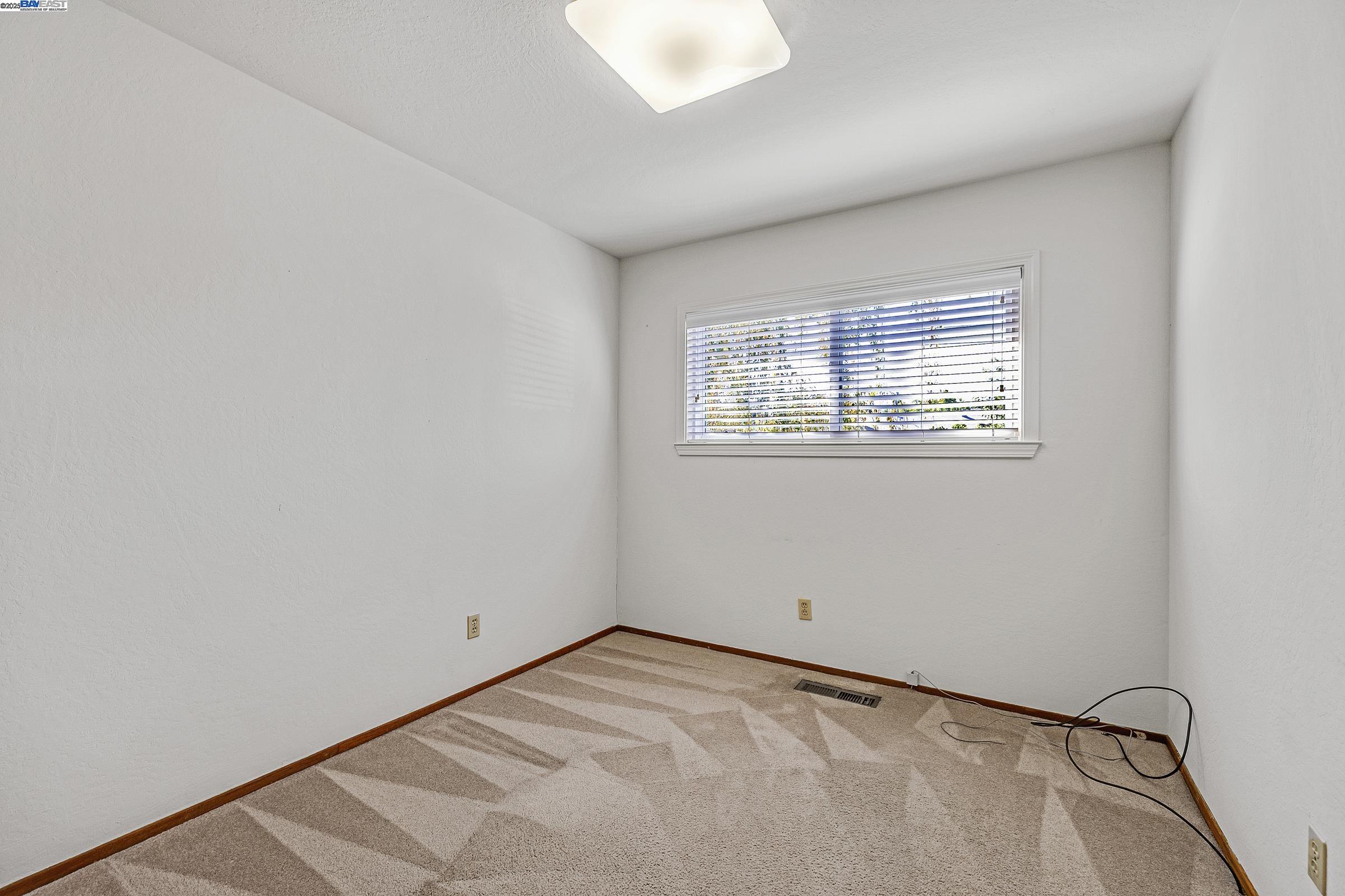 596 Tyler Avenue Livermore, CA 94550 - Photo 21 of 36 an empty room with a window