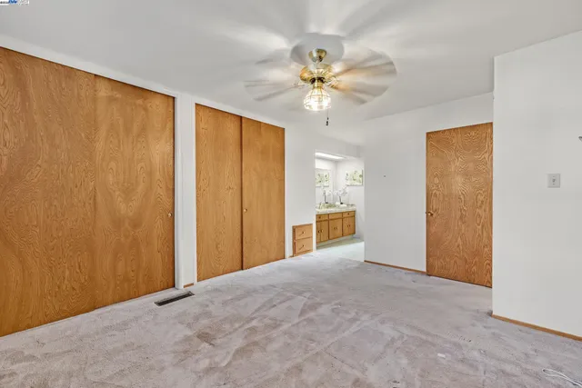 a view of a big room with wooden floor and closet area