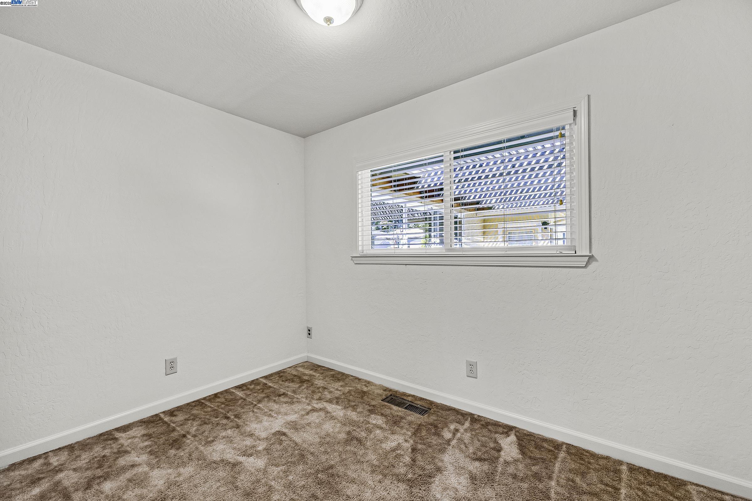596 Tyler Avenue Livermore, CA 94550 - Photo 27 of 36 an empty room with a window