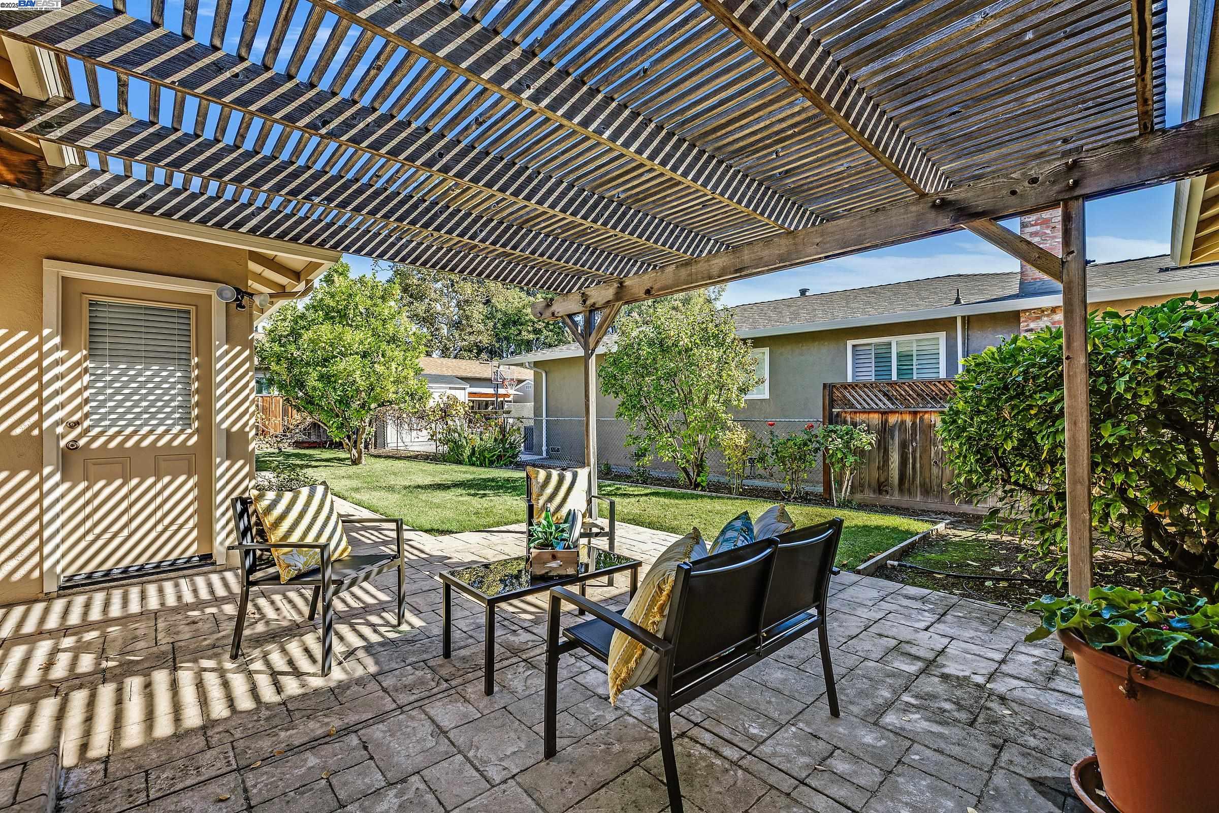596 Tyler Avenue Livermore, CA 94550 - Photo 29 of 36 a view of a patio with table and chairs and potted plants