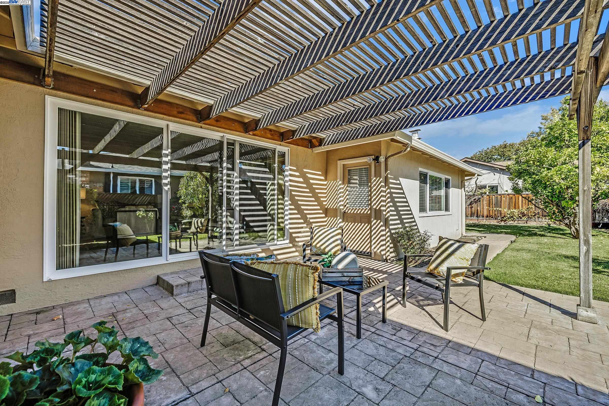 596 Tyler Avenue Livermore, CA 94550 - Photo 30 of 36 a view of a patio with table and chairs and potted plants