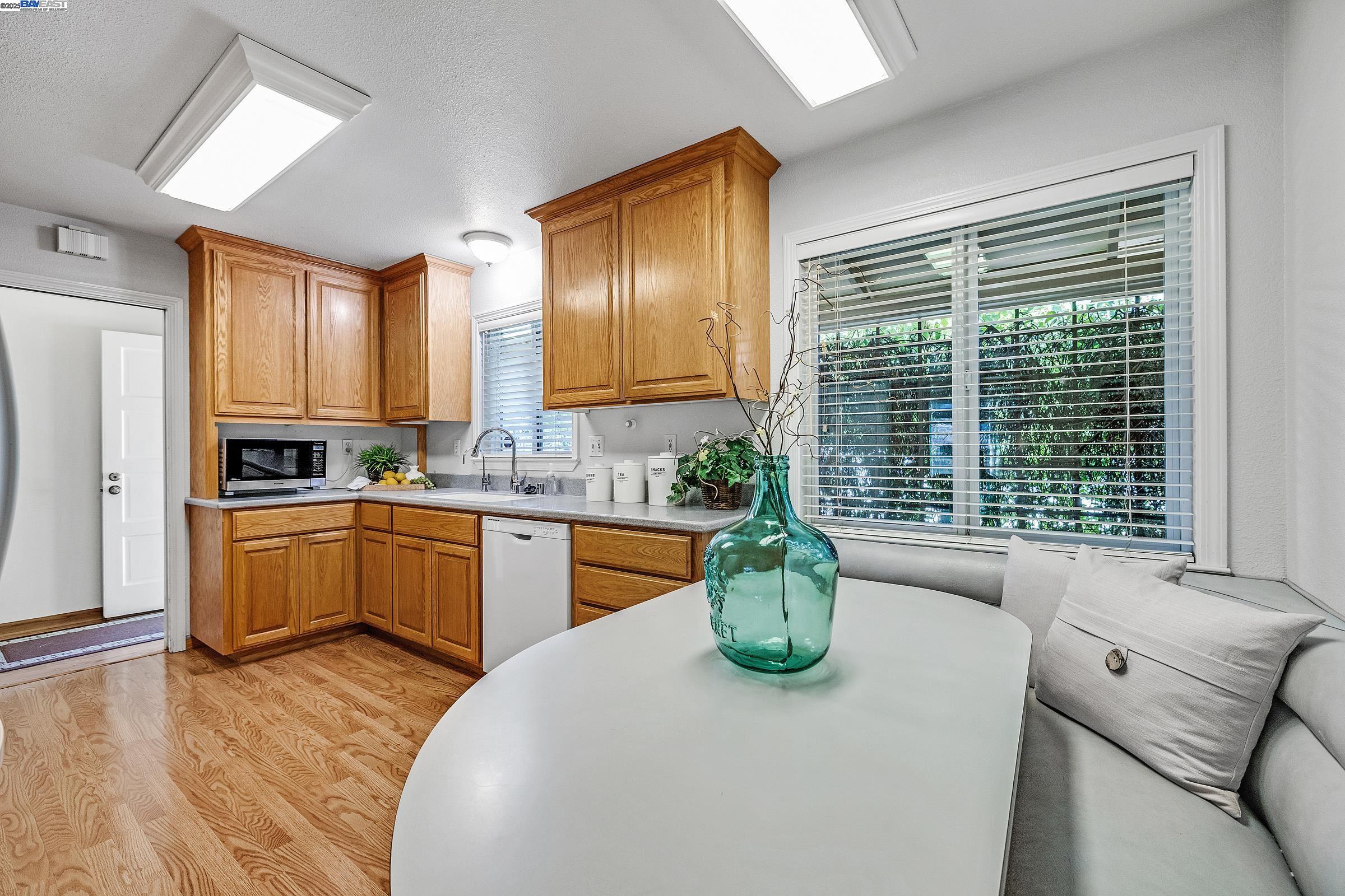 596 Tyler Avenue Livermore, CA 94550 - Photo 4 of 36 a kitchen with a window dining table and chairs