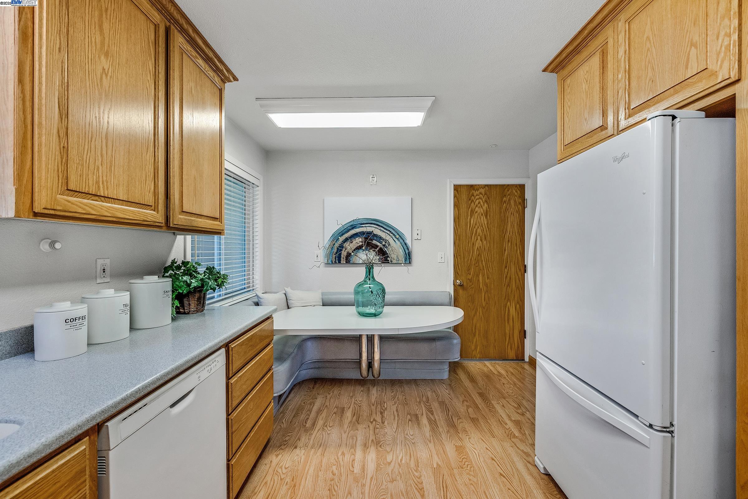 596 Tyler Avenue Livermore, CA 94550 - Photo 5 of 36 a kitchen with a refrigerator and a sink