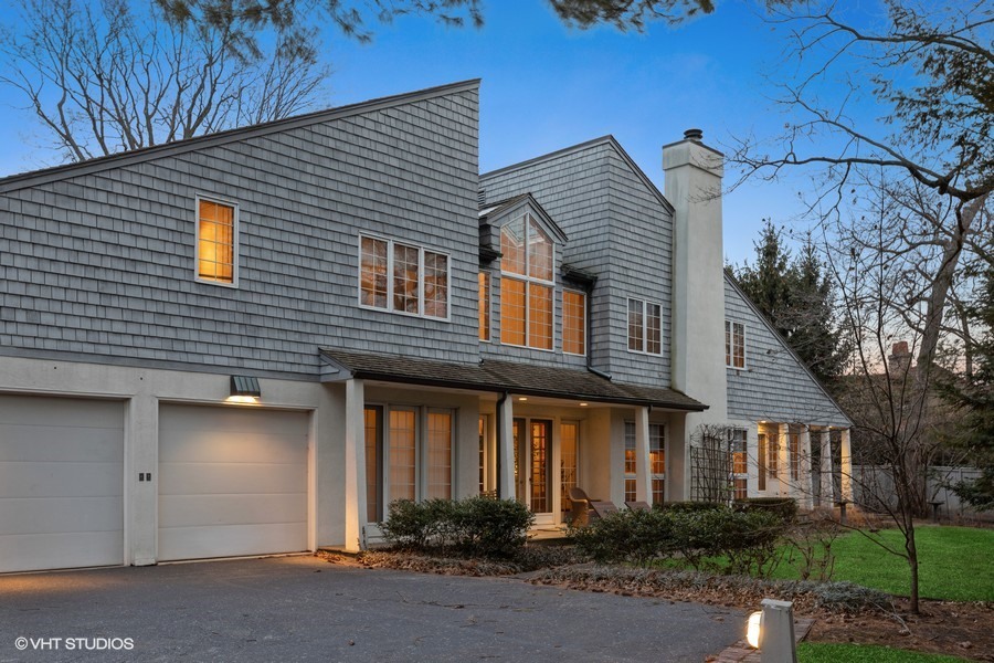 349 Sheridan Road Winnetka, IL 60093 - Photo 1 of 65 a front view of a house with a yard and garage